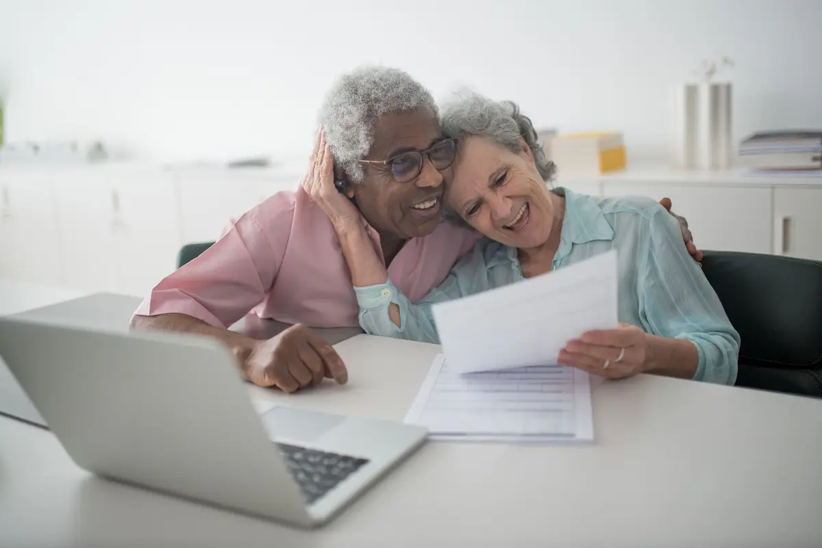 Older couple reviewing paperwork at home